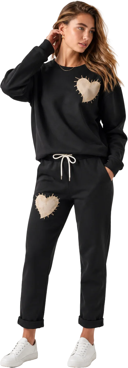 Crystal Fashions model wearing a heart-patch sweatshirt and jogger set from the Modes Crystal Fashions collection